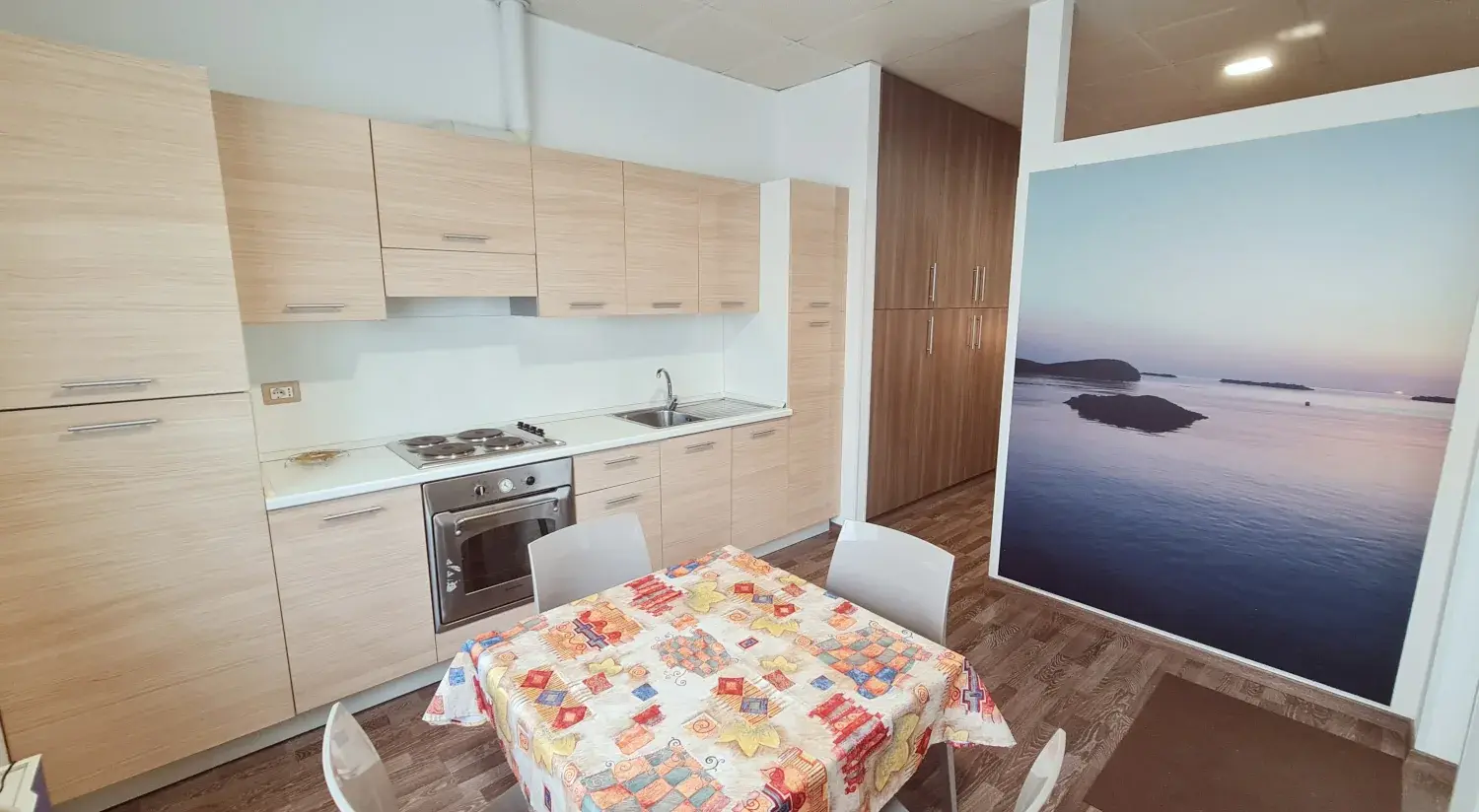 Zona giorno di un bilocale del Residence Miramare a Pineto, con tavolo e angolo cottura